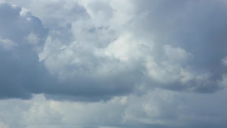 Intrinsic-play-of-cumulus-rain-clouds-forming,-disappearing-and-stumbling-over-one-and-other-in-cinematic-closeup-detail-texture-view