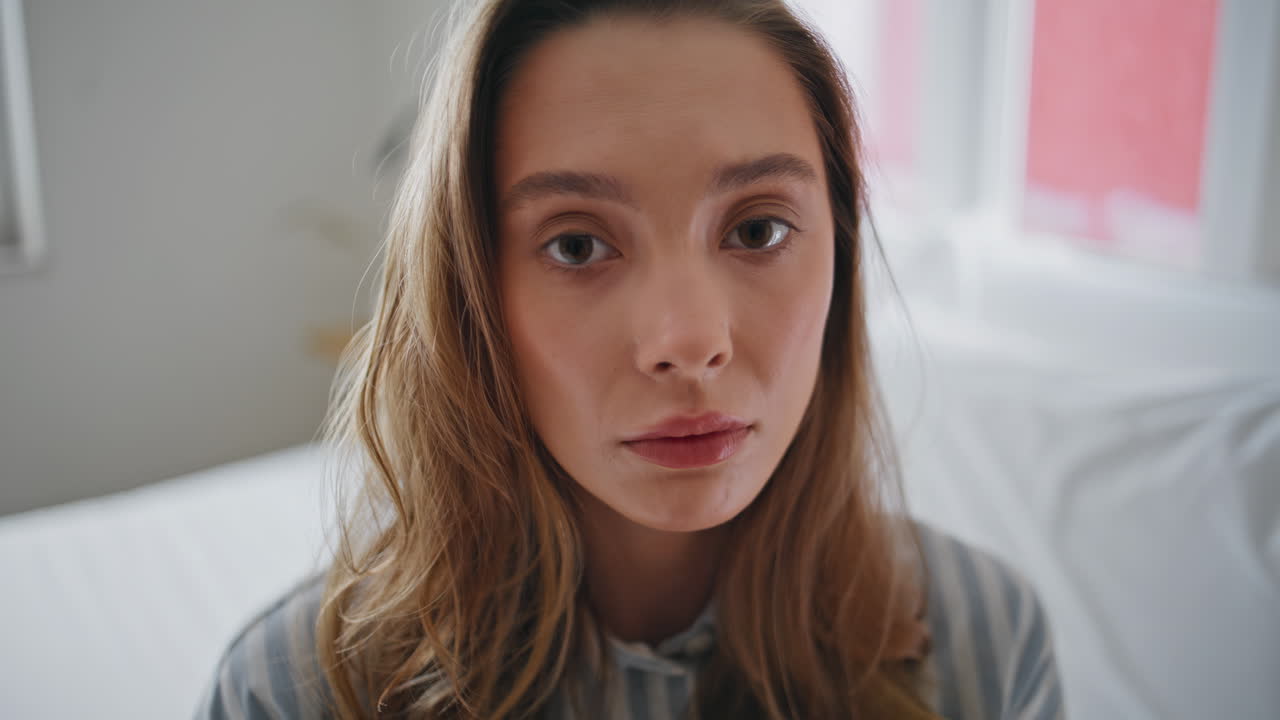 Closeup woman resting bedroom feeling tired at morning light. Portrait girl bed
