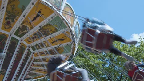 close swing carousel rotates in front of blue sky