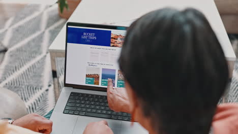 senior couple browsing travel website on laptop