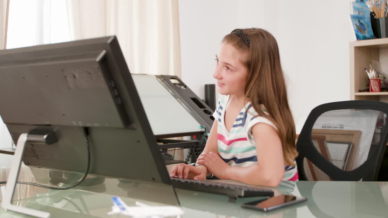A girl working on a computer at a desk