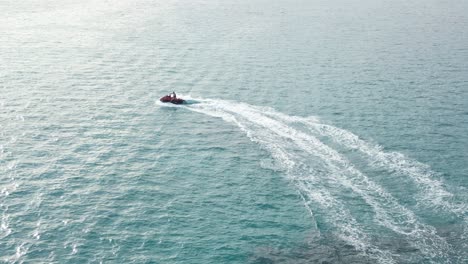 person riding jet ski on blue sea water on sunny day