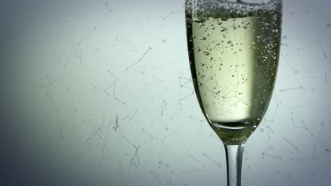 Animation-of-network-of-connections-over-glass-of-champagne