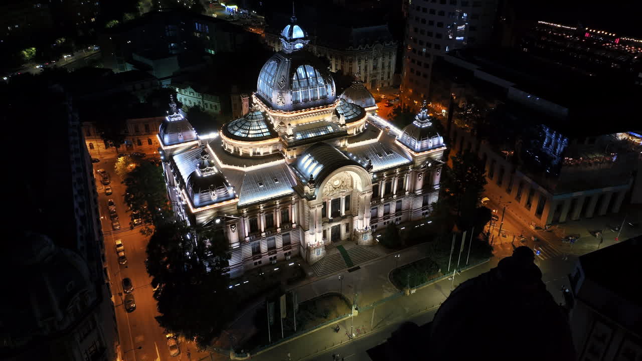 Aerial drone view of the Palace of the Deposits and Consignments illuminated in Bucharest, Romania at night