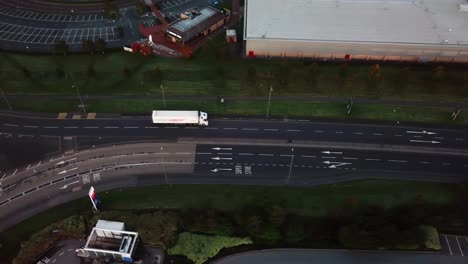 Panning-right-aerial-over-road-with-truck-passing-through