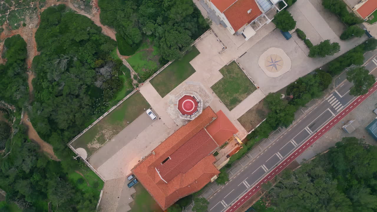 Top roof building surrounded by green nature. Drone shot red-tiled rooftop