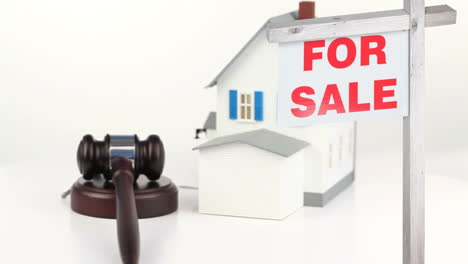 animation of house for sale sign and house on white background