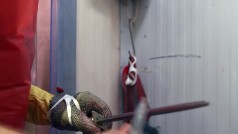 Butcher-wearing-protective-glove,-sharpening-his-knife