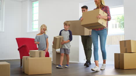 family unpacking boxes in new home on moving day