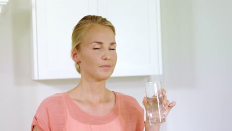 portrait of smiling woman drinking water