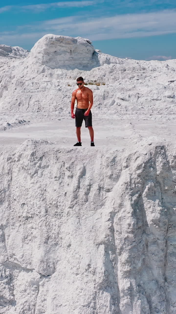 Professional bodybuilder posing. Concept of sport outdoors. Vertical video