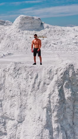 professional bodybuilder posing. concept of sport outdoors. vertical video