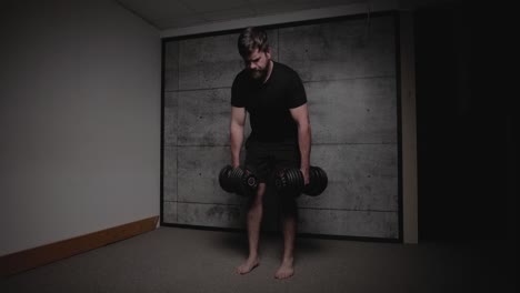 Dumbbell-Romanian-deadlift,-cinematic-lighting,-white-man-dressed-in-black-gym-attire