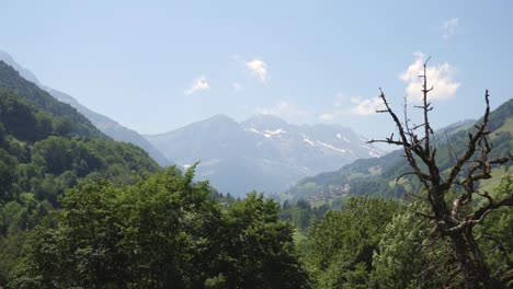 aerial footage over a lush green alpine valley