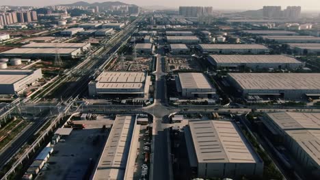 aerial view of a massive industrial complex showcasing expansive warehouses and infrastructure in a modern urban environment