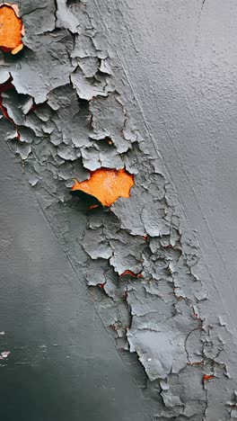 peeling paint on a gray metal surface