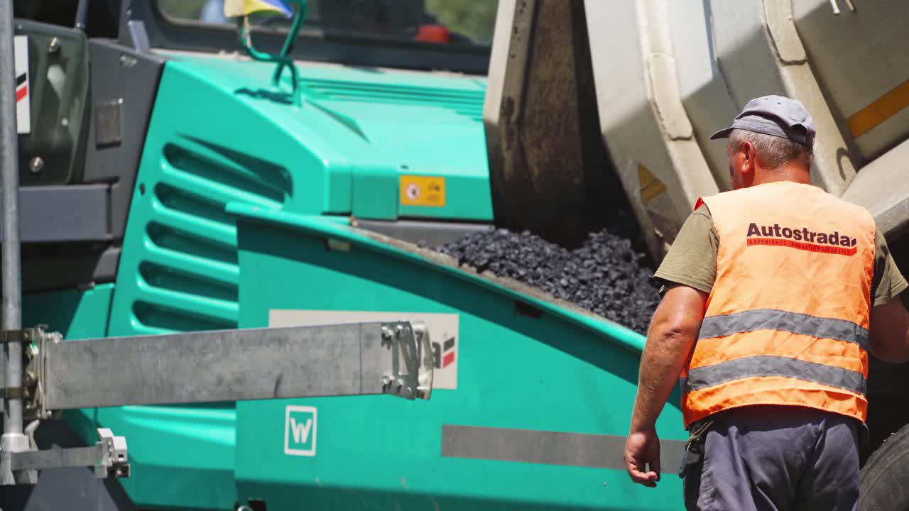 Road worker repair asphalt. Worker during road highway repairing works