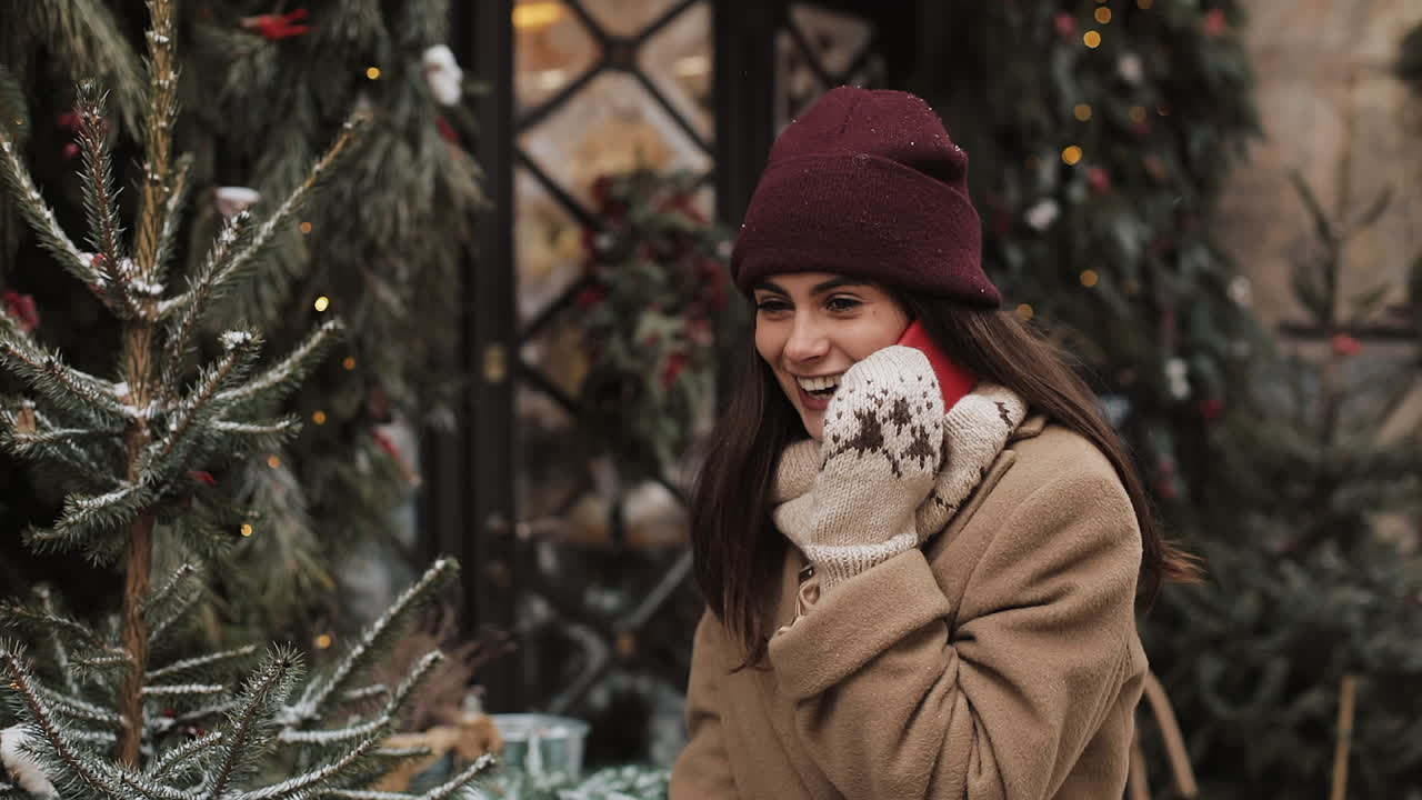 Woman talking on the phone near Christmas tree