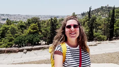 woman taking selfie with athens cityscape view, greece