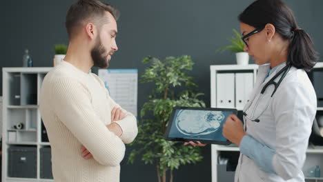 doctor reviewing brain scan with patient