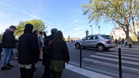 group of people crossing a busy street