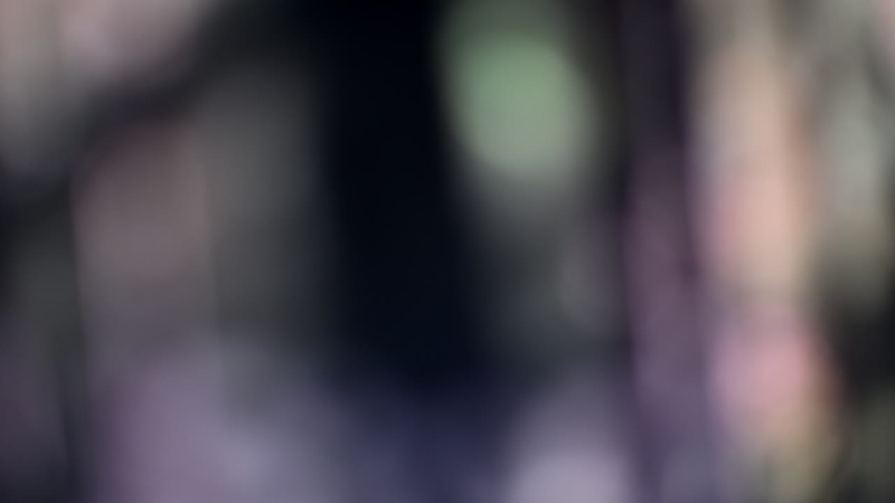 Abstract blurred background with green, pink, and dark tones