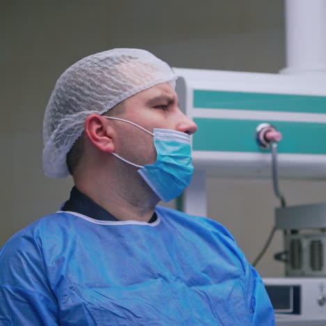 surgeon during the operation. professional doctor in medical uniform performs an operation to a patient together with nurse in the hospital.