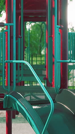 a red and blue playground slide in a park