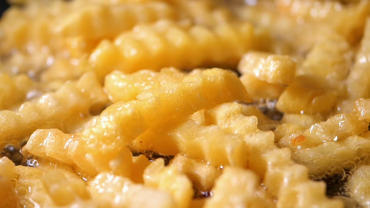 Close-up of French Fries Deep Frying in Hot Oil