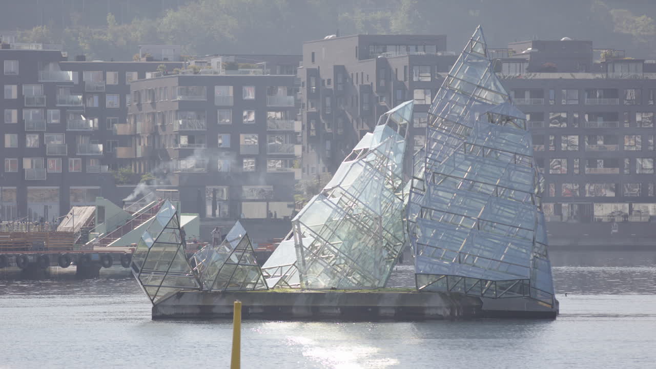 She Lies public sculpture made of glass panels and stainless steel in Oslo Fjord