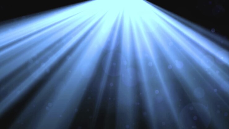Blauwe lichtstralen met zwevende deeltjes op zwarte achtergrond