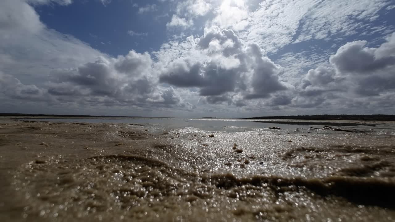 Beautiful landscape worms eye view shot of a tropical wet sand bar in the Guara&iacute;ras Lagoon of Tibau do Sul, Brazil in Rio Grande do Norte during a sunny summer cloudy day near Pipa