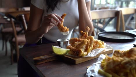 a woman eating her delicious lunch in fancy restaurant, close up shot,insert shot