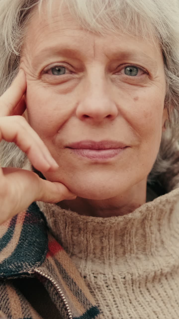 Close-up Portrait of a Thoughtful Senior Woman Looking at Camera