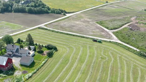 Aerial-View-Of-Tractor-Working-In-Scenic-Field---drone-shot