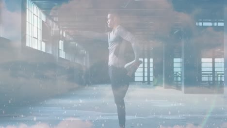 animation of clouds over african american sportsman stretching