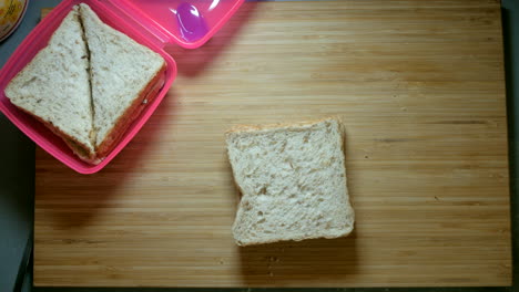 multigrain bread with margarine and honey being drizzled onto the bread