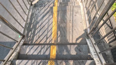 a person walking down a metal staircase