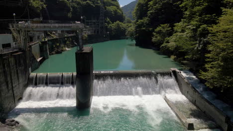 aerial tilting down over small dam in kochi prefecture on the island of shikoku, japan