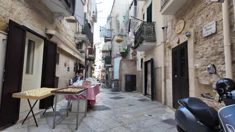 women making homemade pasta on strada delle orecchiette, bari, italy