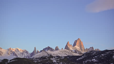 sunrise timelapse of mount fitz roy in patagonia glowing with colorful orange-red hues