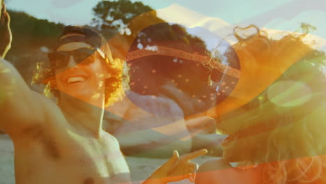 animation of waving flag of brazil over group of friend having fun on the beach