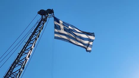 greek flag waving in slow motion in thessaloniki, greece