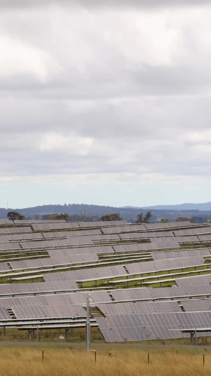 Rows of solar panels across rural terrain