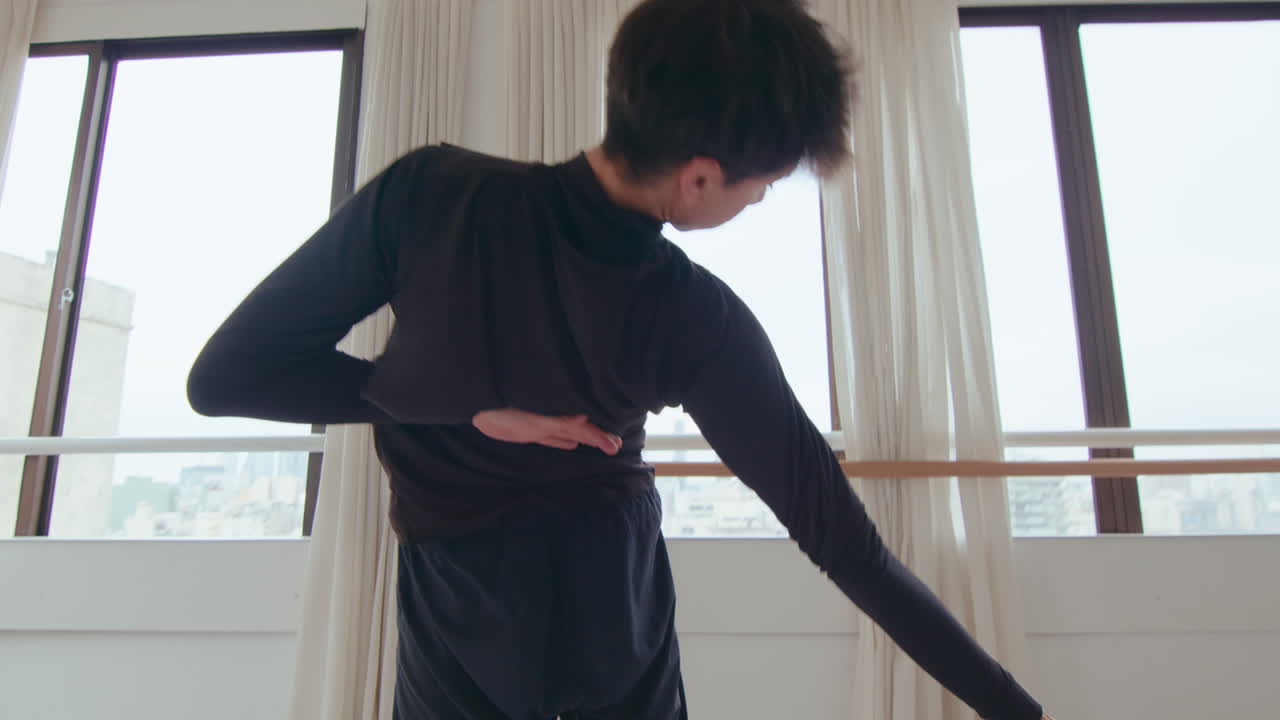 Young Artistic Man Dancing Contemporary Dance in Studio