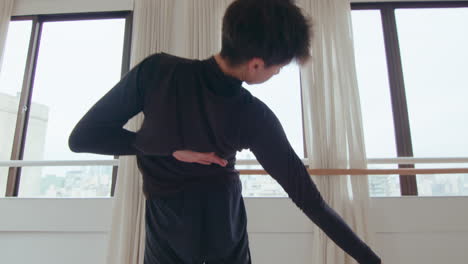 young artistic man dancing contemporary dance in studio