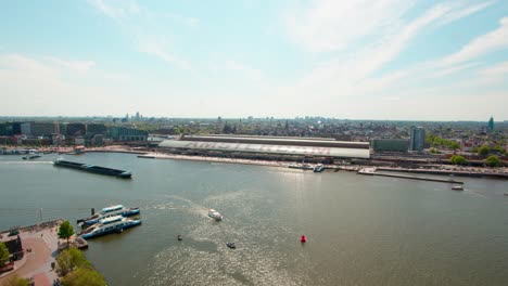 Panoramic-Aerial-View-Of-Ij-River-And-Amsterdam-Central-Station,-The-Netherlands