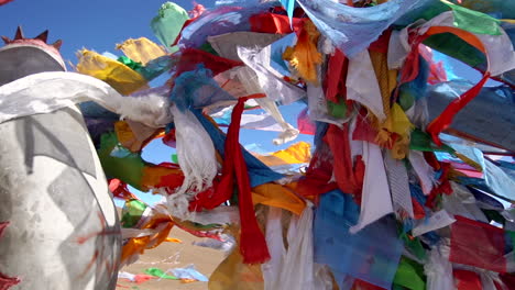 orbital shot of buddhist prayer flags swaying in the wind in the mountains