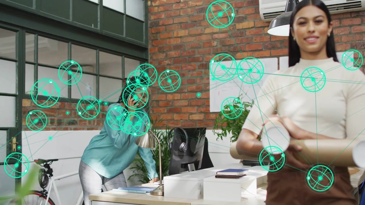 Vertical video: Entering cream with plans as teal blouse on phone at desk for review, green spheres