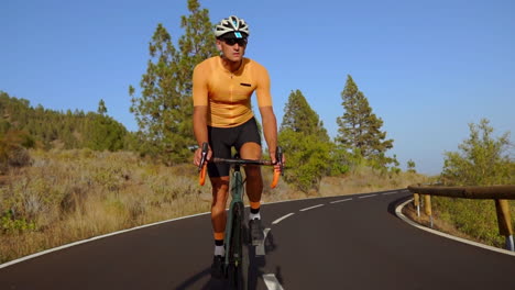 a man rides his road bike on an empty morning road, partaking in outdoor exercise. the slow-motion footage underlines the thrill of extreme sports